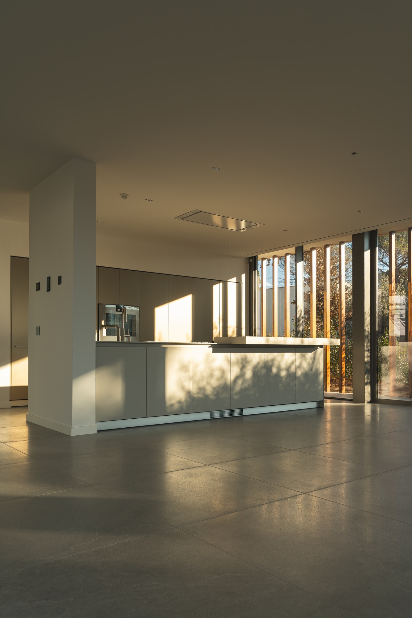 Interior view of a kitchen in a brand new luxury home with gray and white tones. Vertical