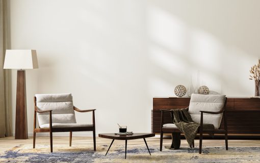 Bright modern living room interior in neutral colors with armchairs, floor lamp, rug and coffee table, chest of drawers with home decor, wide empty wall, 3d render